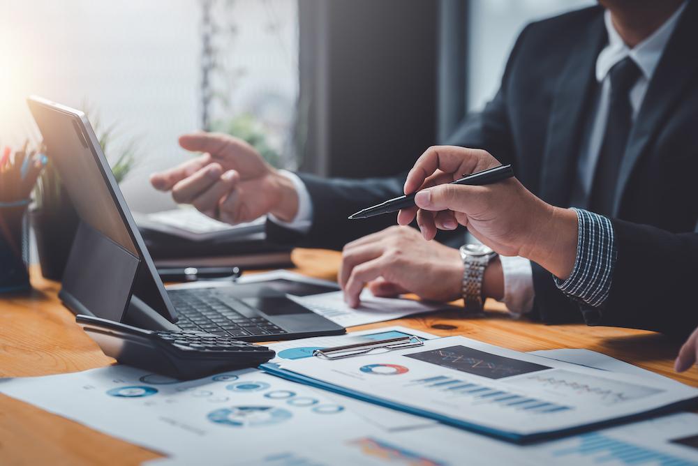 Business people meeting explaining the financial graph data and marketing plan. Group of business people at meeting assessment the state of business investment and marketing.